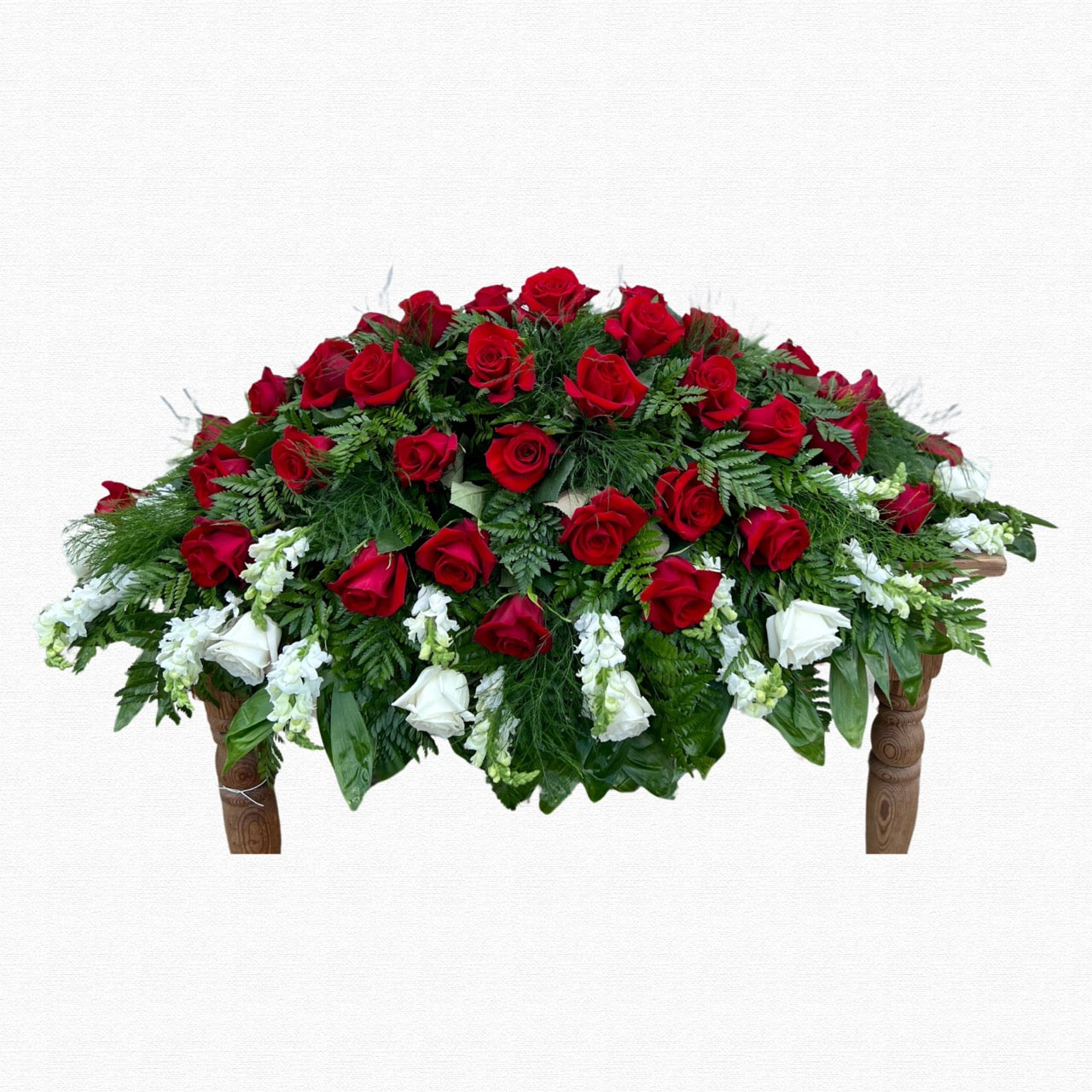 Red and white patriotic casket spray by Historic Dade City Florist