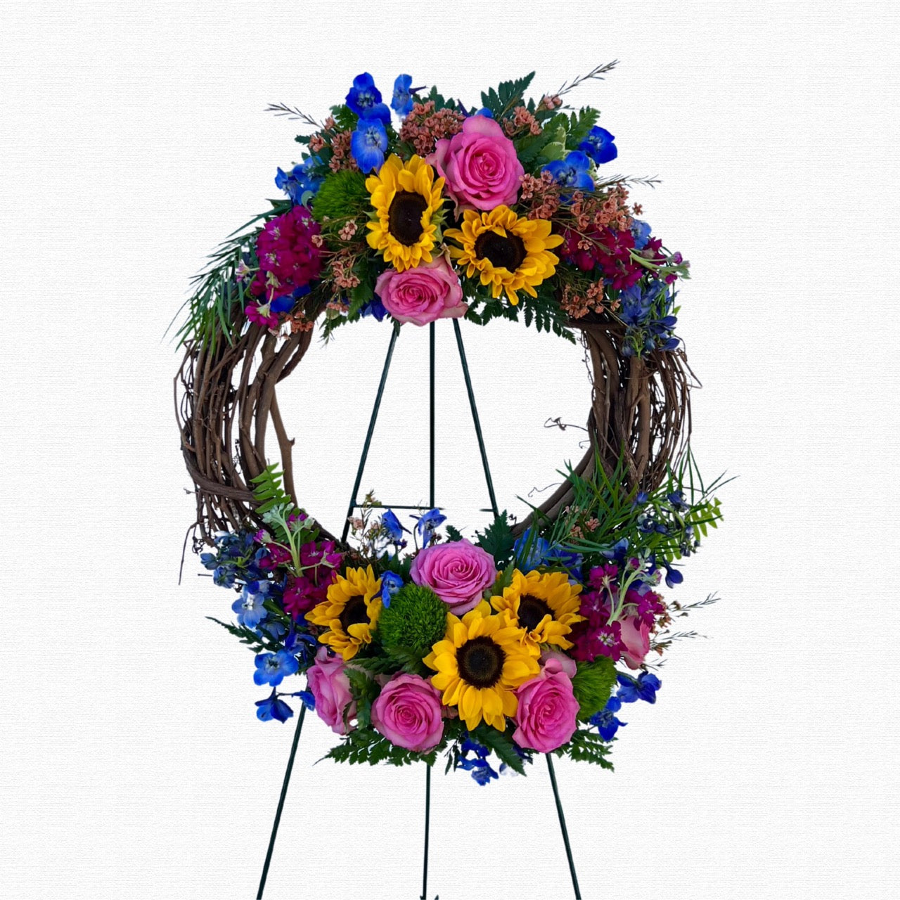 Natural grapevine funeral wreath with yellow flowers by Historic Dade City Florist