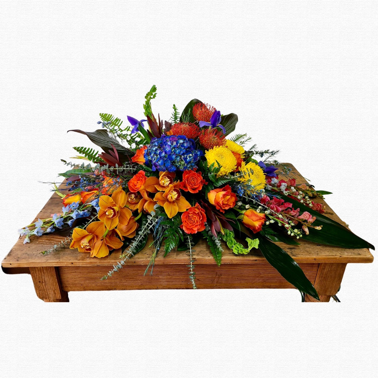 Tropical multicolor casket spray arrangement by Historic Dade City Florist
