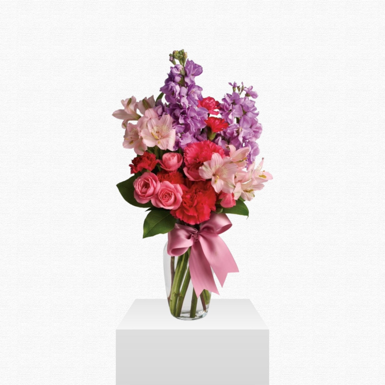 Pink and purple celebratory flower arrangement by Historic Dade City Florist