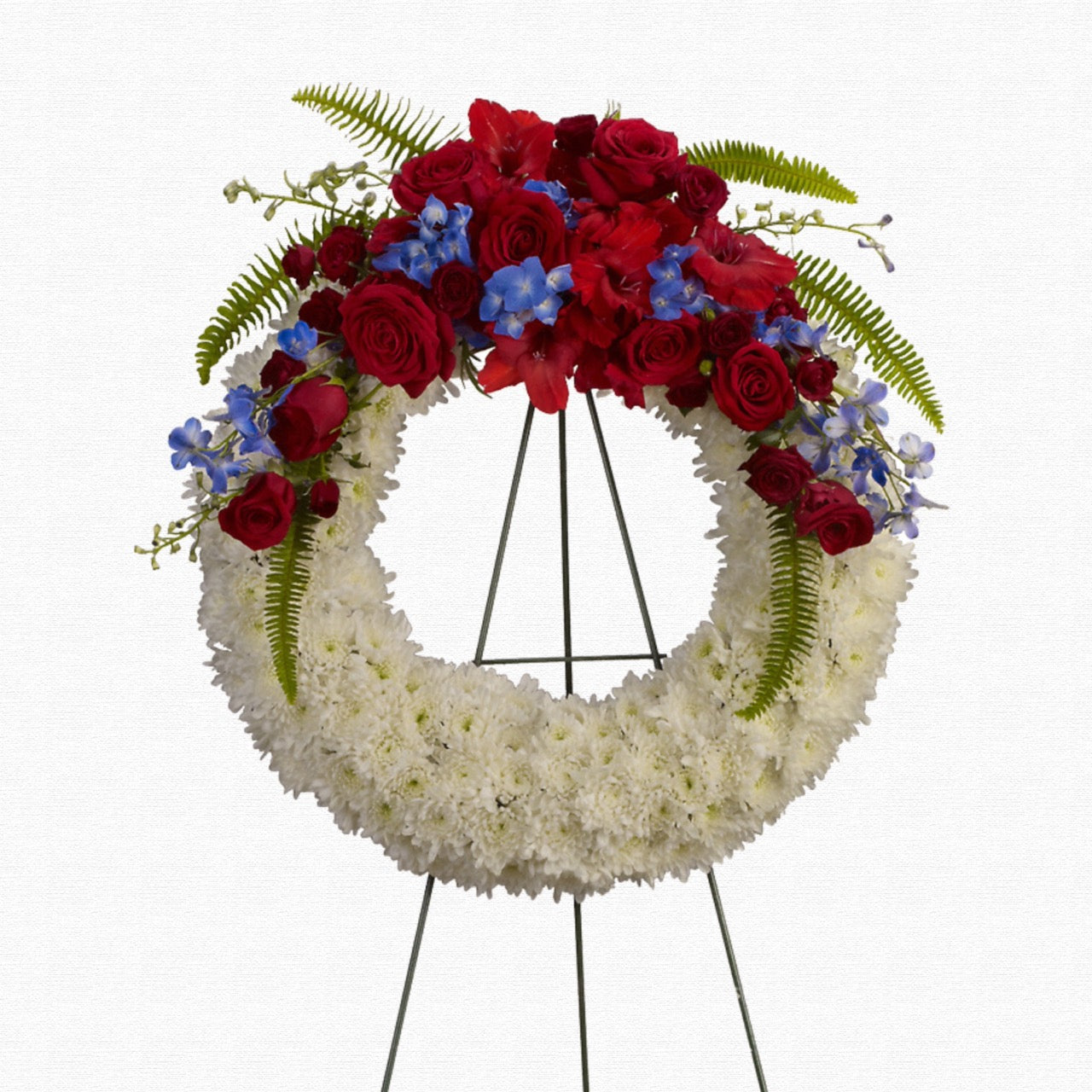Patriotic red, white, and blue funeral wreath by Historic Dade City Florist