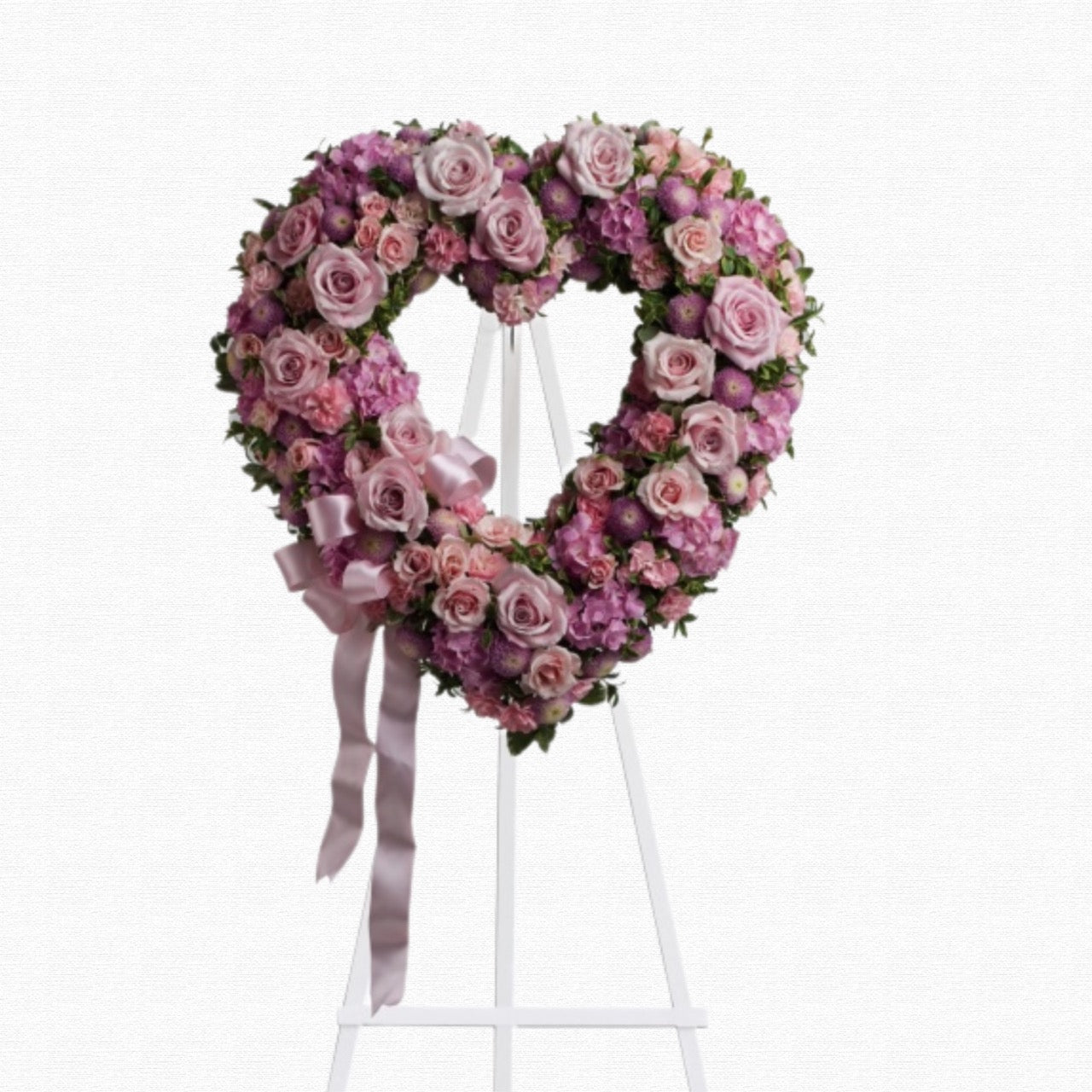 Pink and purple heart-shaped funeral tribute by Historic Dade City Florist
