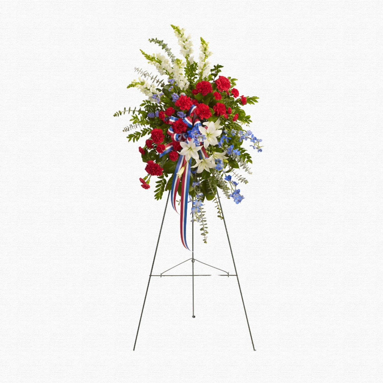 Patriotic red, white, and blue funeral spray by Historic Dade City Florist